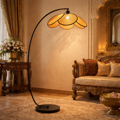 modern rattan floor lamp with an arched metal stand and woven rattan shade.