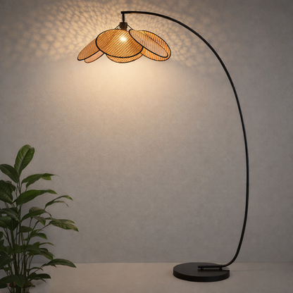 modern rattan floor lamp with an arched metal stand and woven rattan shade.